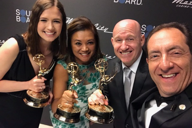 The team for "Sh*t Saves the World" proudly holding their Emmys on the red carpet