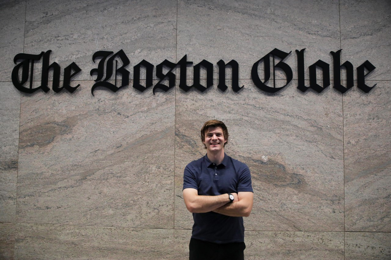 Antaya standing in front of The Boston Globe