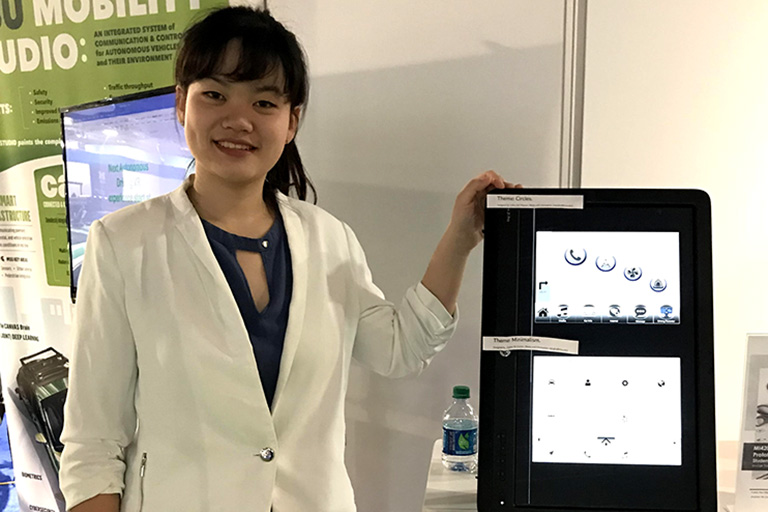 Jinghan Ni poses with her prototype at the Detroit Auto Show.