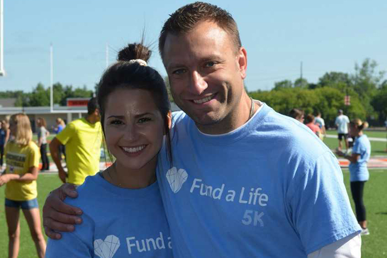 Junior Breanna Cockerill poses with her former coach, Mark Howell, after the Fund a Life 5k.