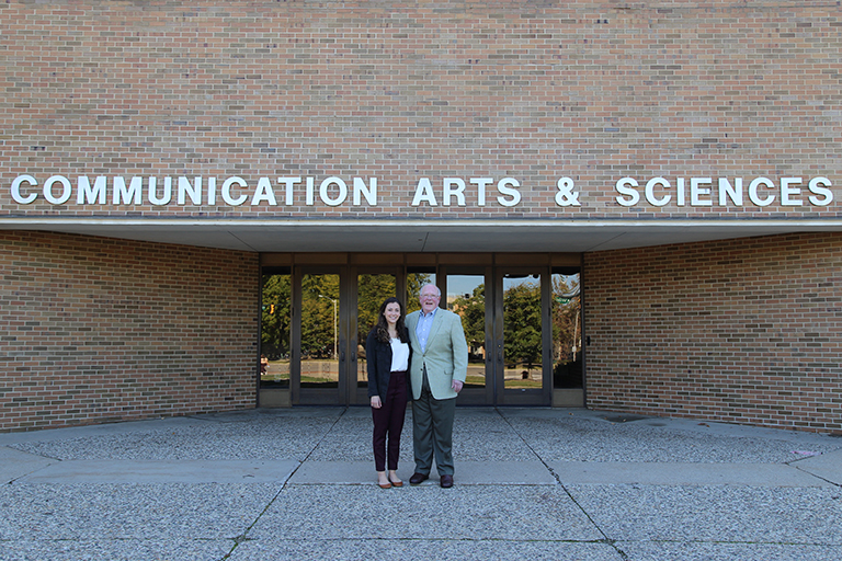 Alumnus Tony Hopp and senior Cara Murphy in front of the ComArtSci building.