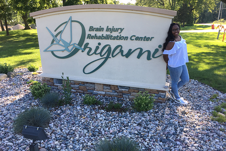 Keyara Newkirk outside her internship at Origami Brain Injury Rehabilitation Center