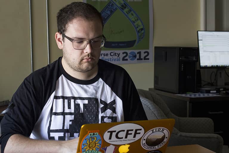 Traverse City Film Festival intern Eric Schwartz working on his computer.