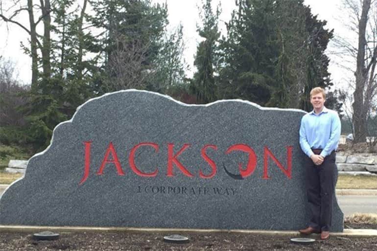 Mitch Marier standing outside next to the Jackson National Life Stone.