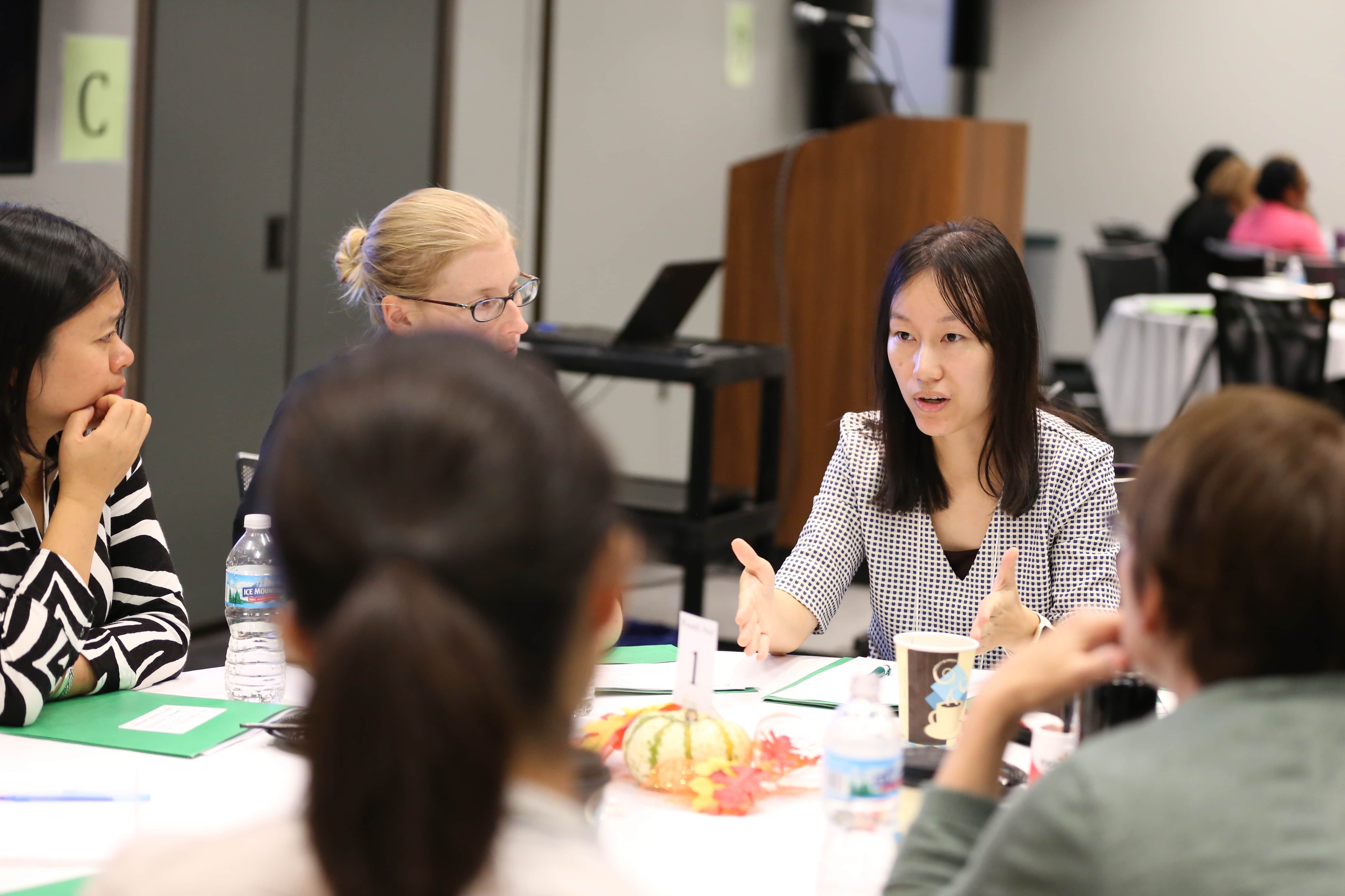 Jingbo Meng, an assistant professor of Communication at Michigan State University, talking with other researchers at the Trifecta kick off meeting.