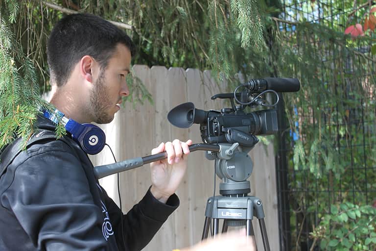 Media and information student filming a scene at the zoo.