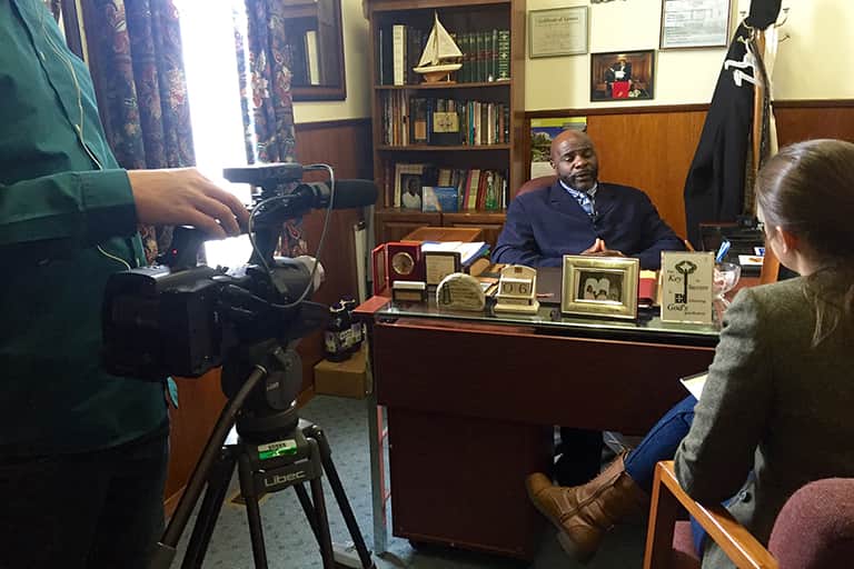 Journalists from Michigan State University interview Pastor Jeffery Hawkins of the Prince of Peace Missionary Baptist Church in Flint. The interview is part of a series WKAR TV and radio is doing looking at how the Flint water crisis has affected the lives of everyday people in the city.