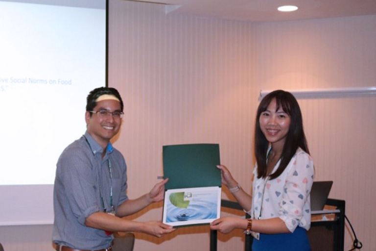 Faculty member Bruno Takahashi presenting ICA award to Alumnus Rain Wuyu LIu