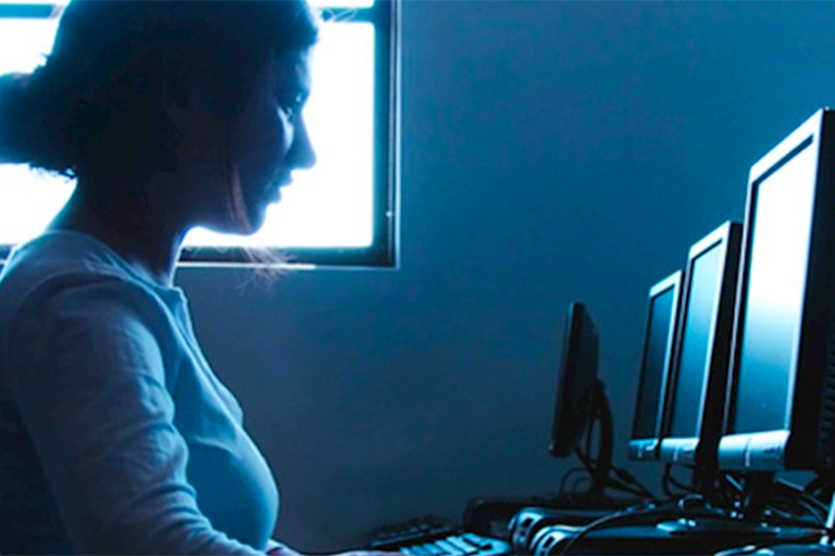 Stock Image of woman sitting at computer