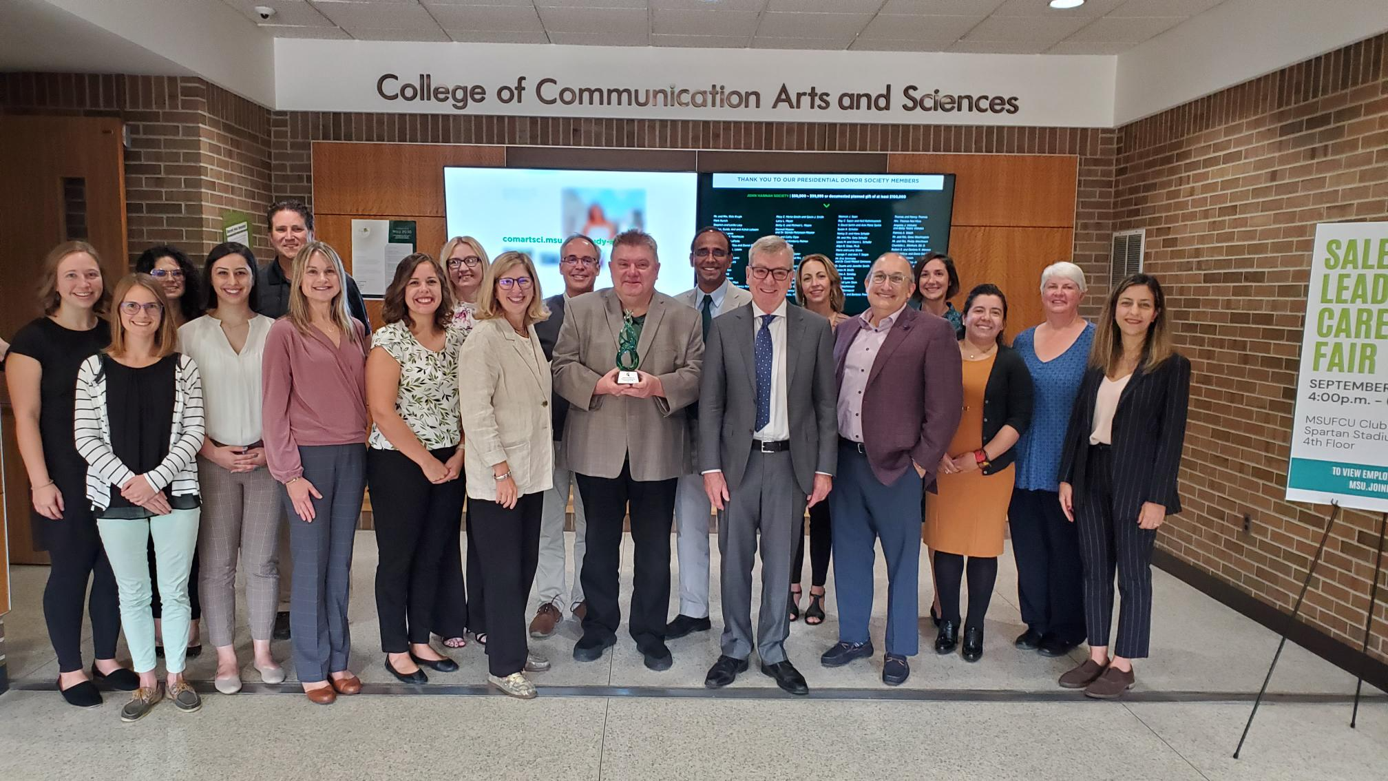 Picture of all of the faculty members in the Department of Communicative Sciences and Disorders in the south lobby of the ComArtSci building