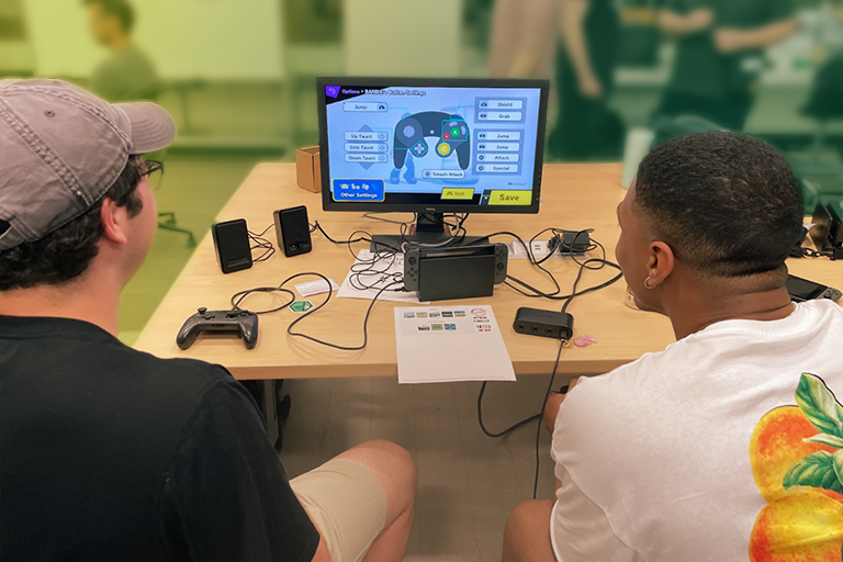 Two MSU students set up a game of Super Smash Bros Ultimate.