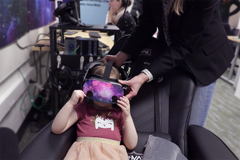 a child gets fitted with the VR headset