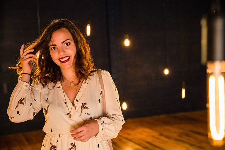 Photo of Thea Neal with hanging lights in the background