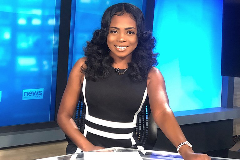 Photo of Sierra Searcy at a news reporting desk