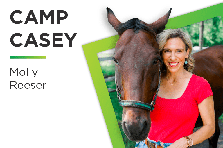 Molly Reeser posed next to a horse from Camp Casey