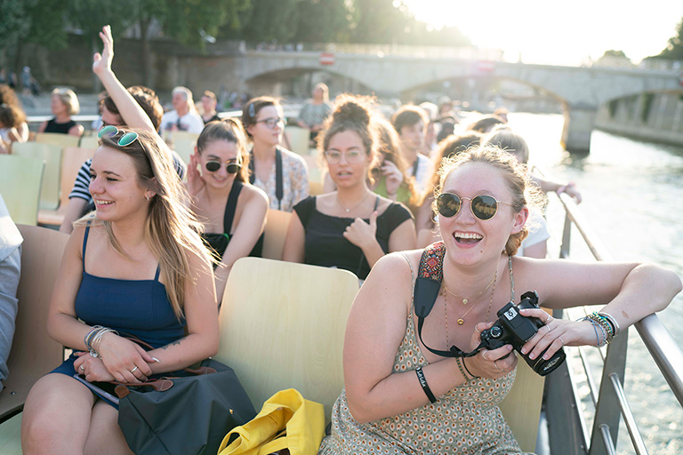 Students on boat taking pictures