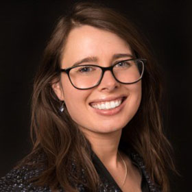 Photo of Morgan Vigil-Hayes with a black background 