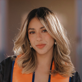 professional graduation photo of young-woman with colored blonde hair, gown on, face frame