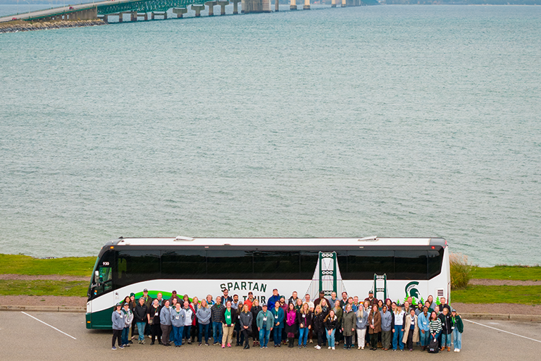 Drone photo of the Spartan bus tour group in front of the bus
