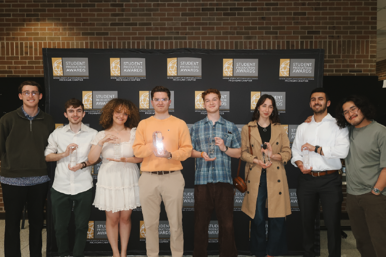Students stand with their awards