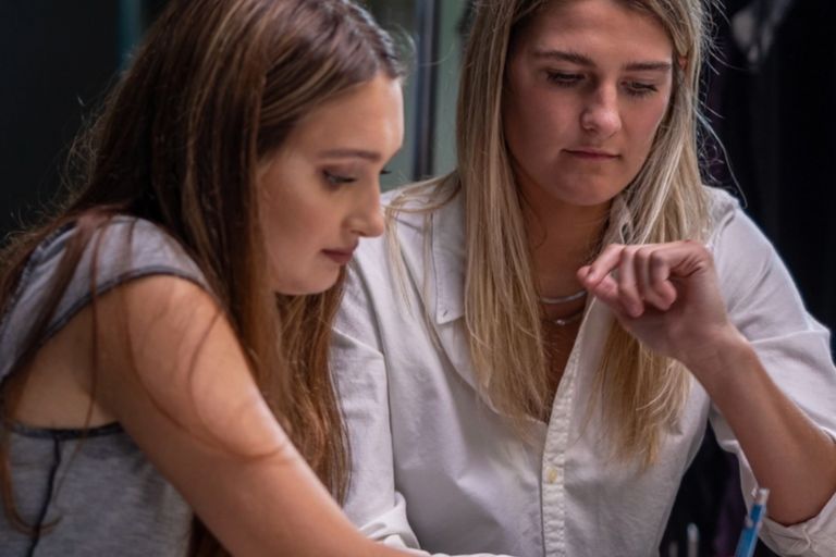 Two advertising students studying to gain professional experience