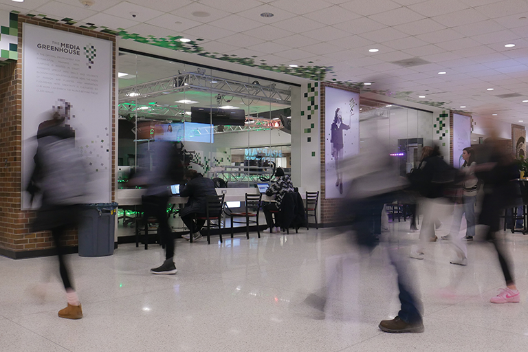 Photo of students walking through the hallways of the ComArtSci building