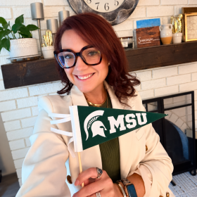 Becky Zimmerman holding MSU banner
