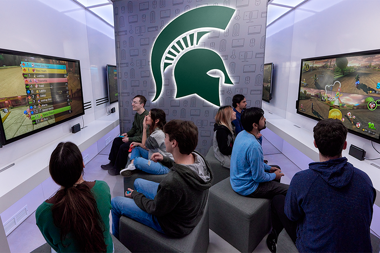 students playing Nintendo Switch games in the console nook of the Alienware MSU Esports Lounge