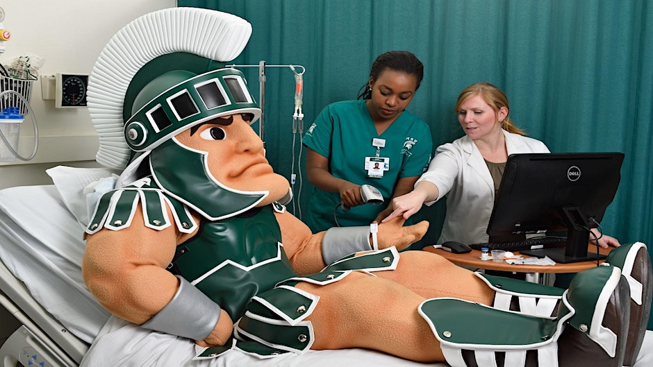 MSU mascot Sparty in a Hospital bed