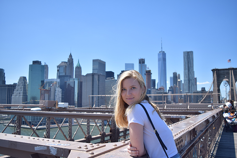 Katie McCoy posing against the New York City skyline.