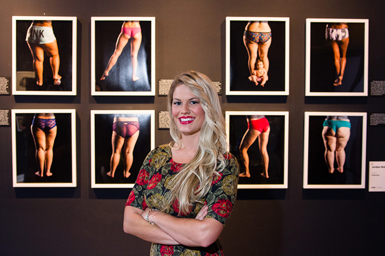 Jordan Noble in front of her displayed work at ArtPrize.