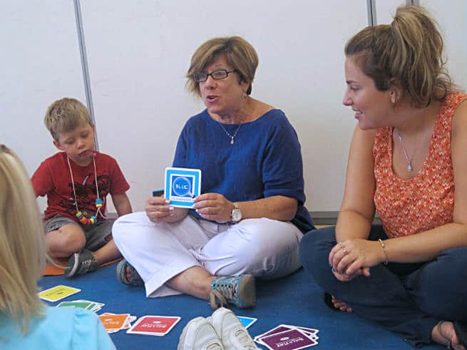 Nancy Reihheimer Kaufman working on a language exercise with children.