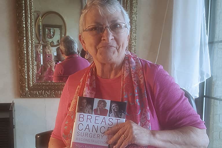 Author Patricia Kiska holding her book, "Brest Cancer Surgery and Reconstruction."