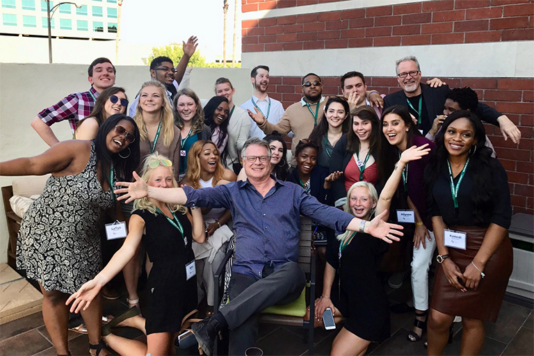 Craig Murray with a group of interns on a rooftop patio