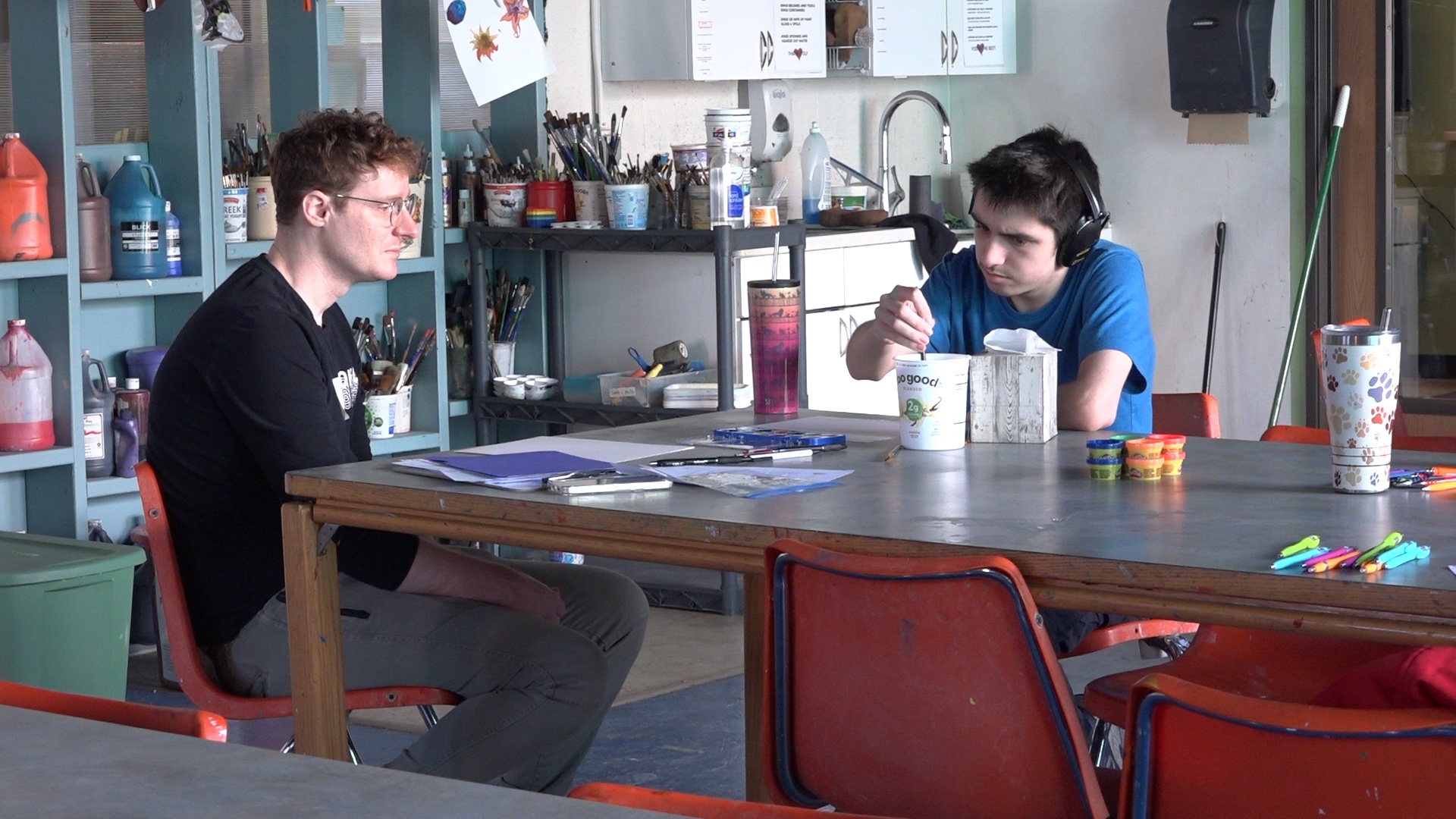 Two students creating art as a practice in the creation of the screening tool.