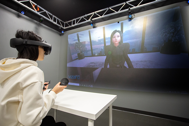 a participant interacts with the embodied agent through the virtual reality headset