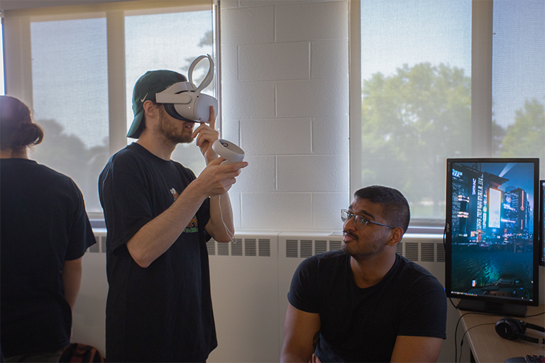 two game design students test a virtual reality environment