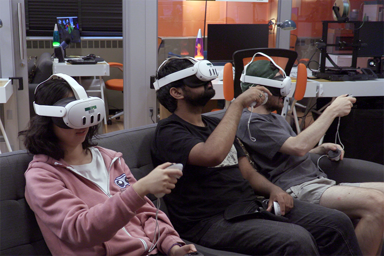 Three SPARTIE Lab students wearing VR headsets