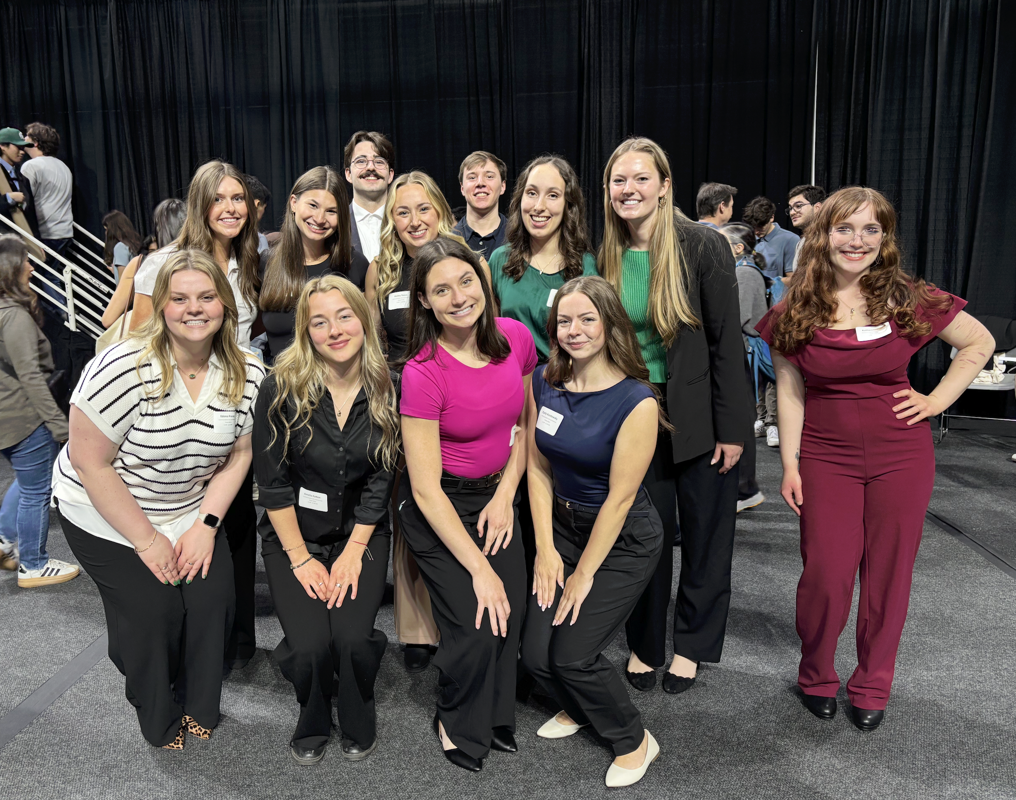 A group of ComArtSci students in between poster presentations at the Breslin Center