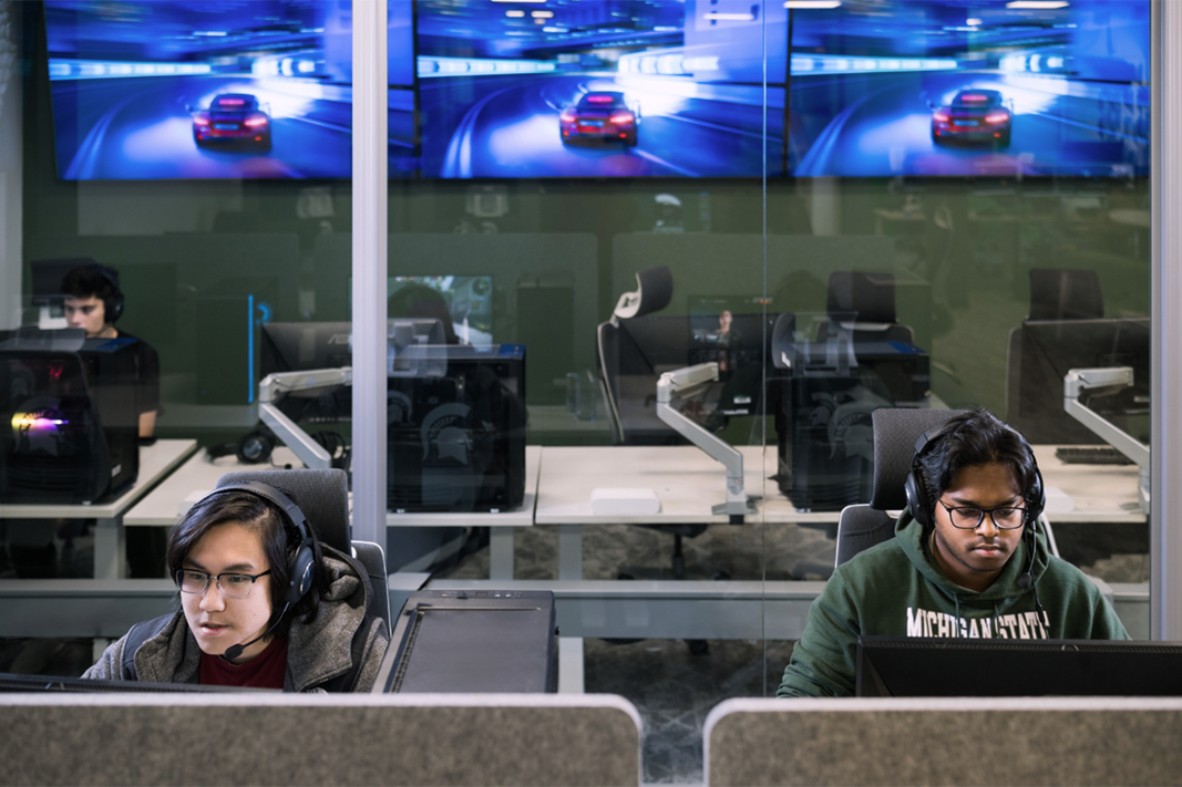 students playing racing games near the competition room in the Hubbard Esports Lounge