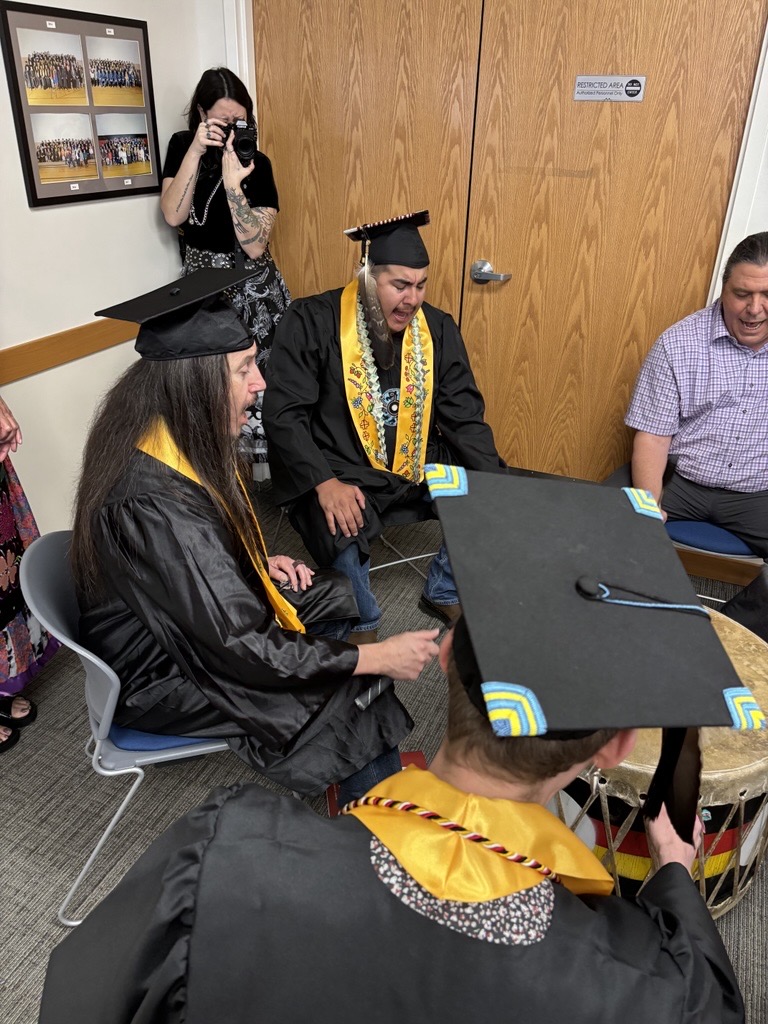 Chelsey photographing graduating native students.