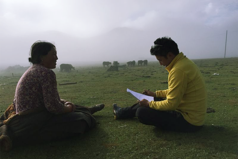researcher speaking with pastoralist in Western China